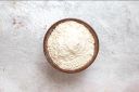 White-colored garlic powder on a wooden bowl